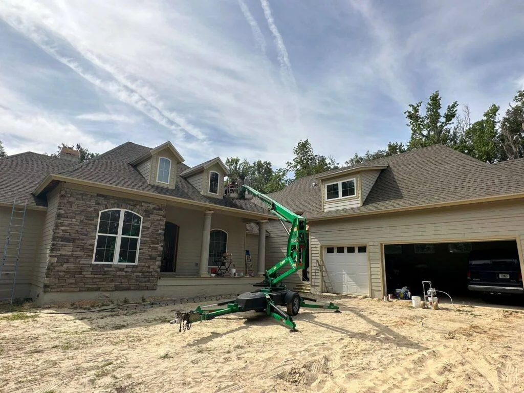 HVR Painting crew painting a house exterior from a lift