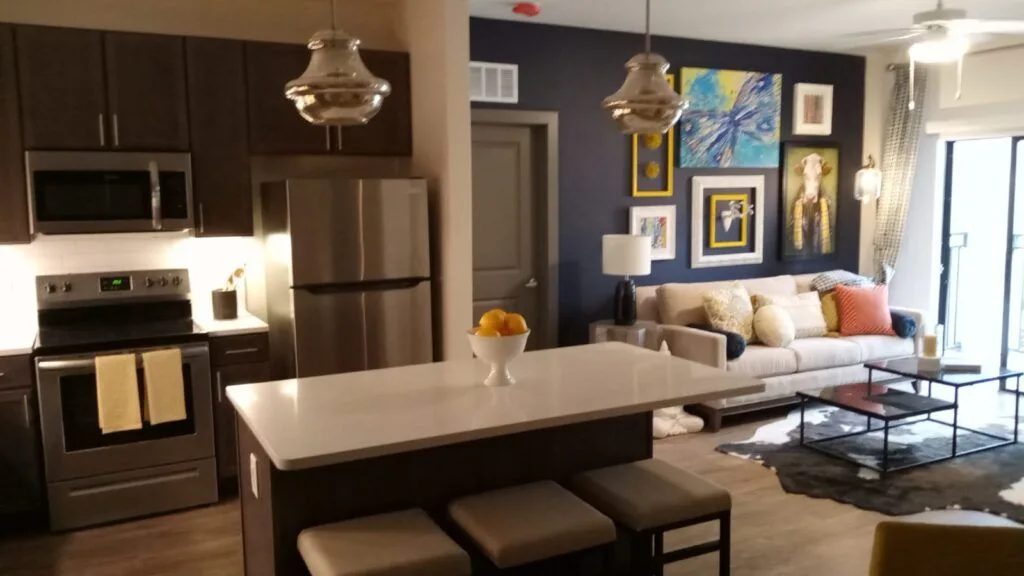 Interior painting of an open living room and kitchen in Gainesville, FL