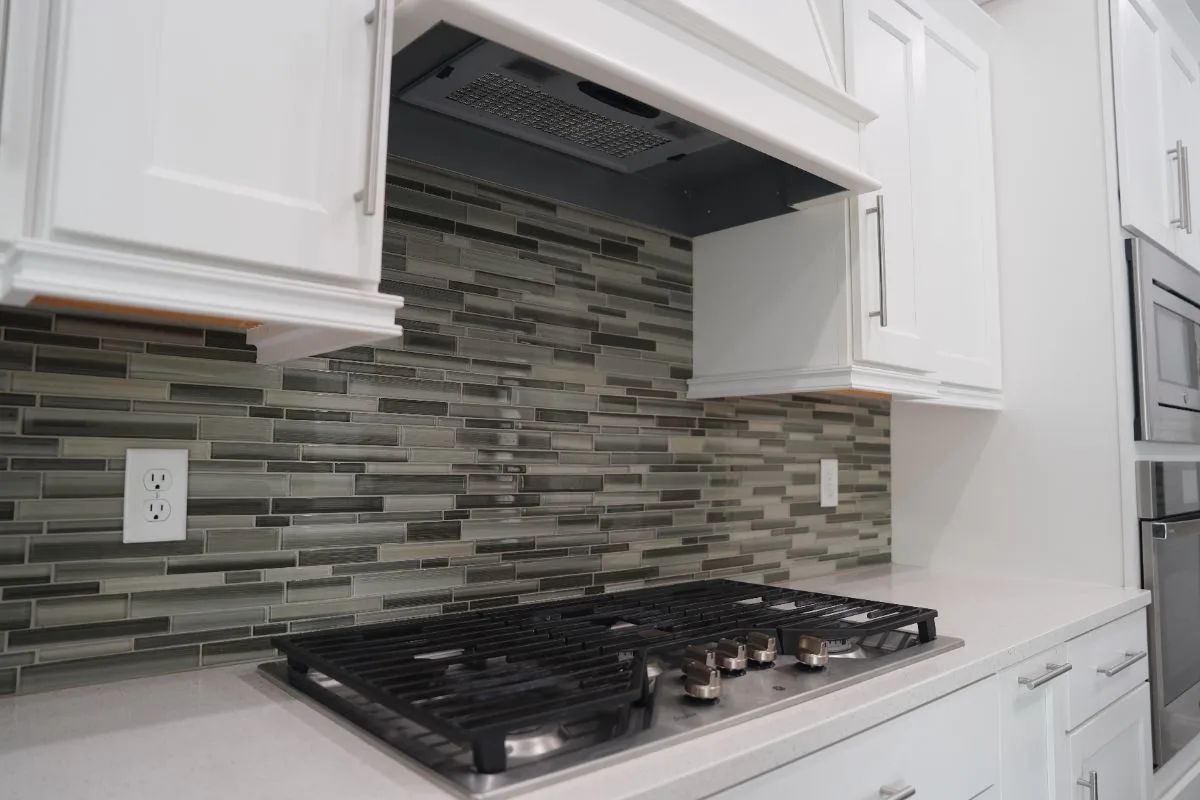White refinished kitchen cabinets with a tile backsplash in Gainesville, FL