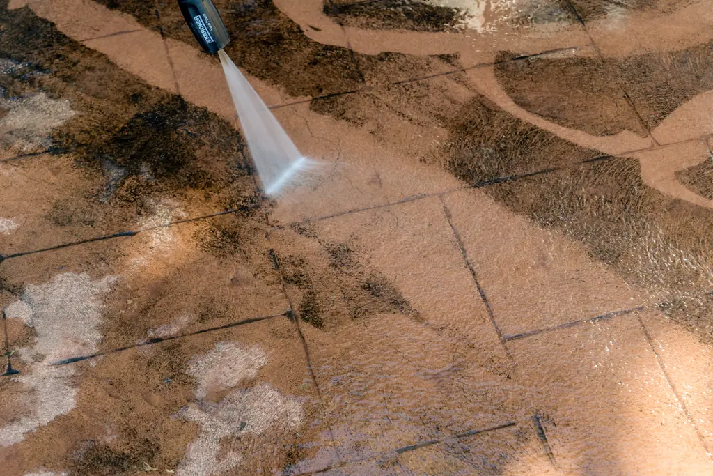 Pressure washing dirt off concrete pavers