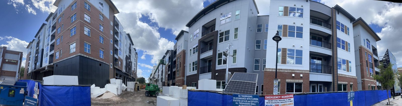 Painting crew working on the exterior of various commercial buildings