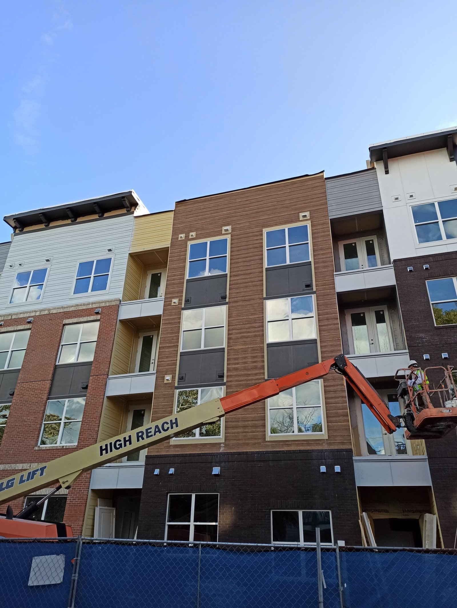 boom lift in action during a large-scale commercial exterior painting job
