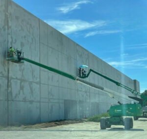 Highly skilled painters in action, achieving a flawless finish on commercial building in Peak logistics Ocala