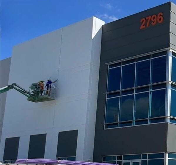 Painting crew working on large commercial building exterior