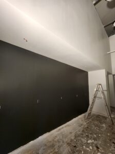 Painters applying fresh coat of paint to living room walls