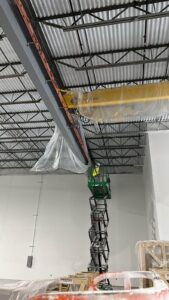 Scissor lift in action during a large-scale commercial interior painting job