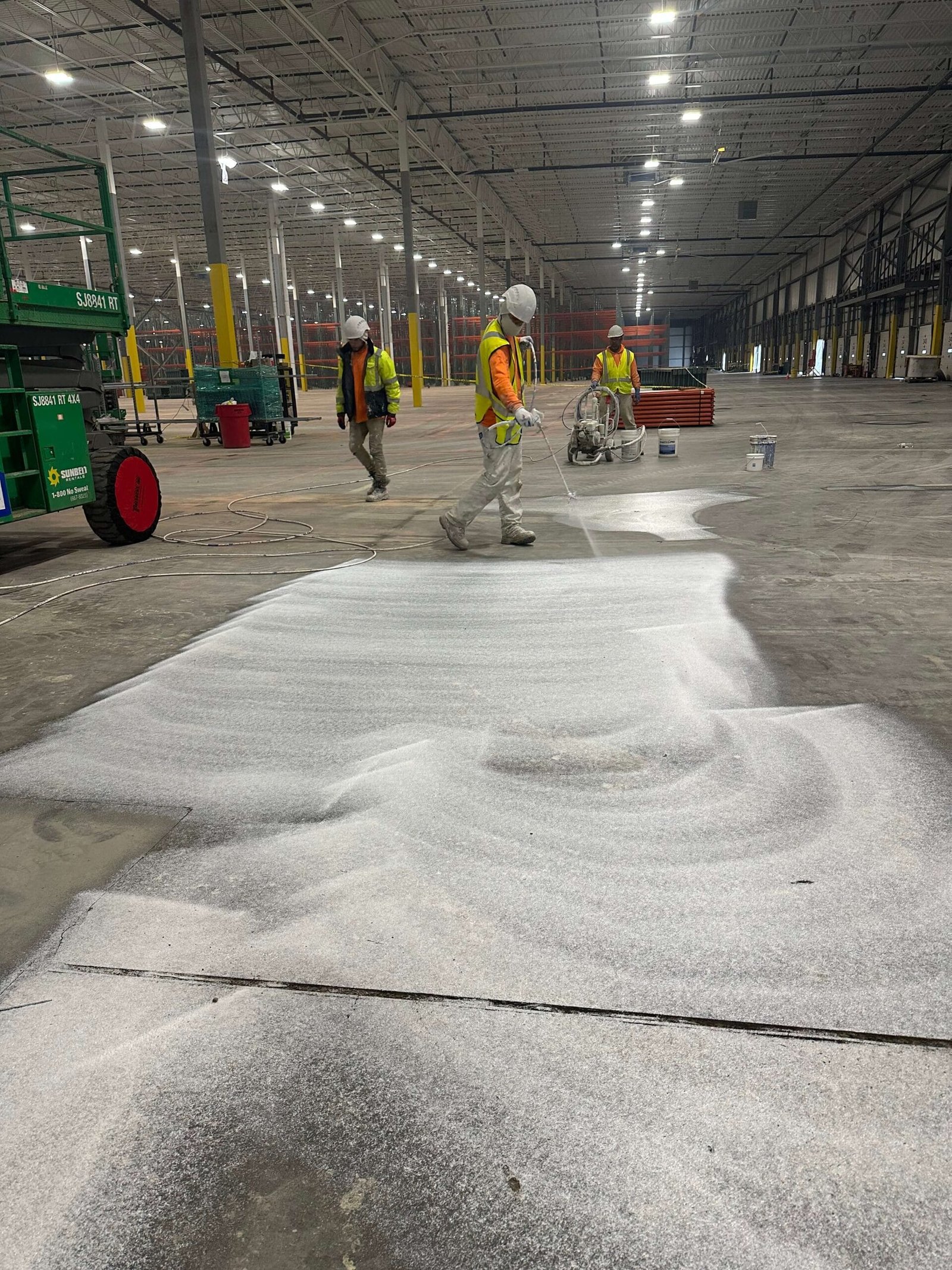 Painting crew working on large commercial building interior